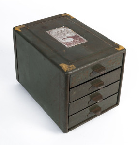 A miniature four drawer tin chest with green painted finish, 17cm high, 15cm wide, 21cm deep