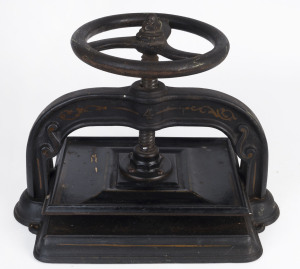 An antique cast iron book press, 19th century, 50cm across