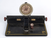 An American LOUIS MARKS tinplate child's toy dial typewriter, circa 1920, 28cm across