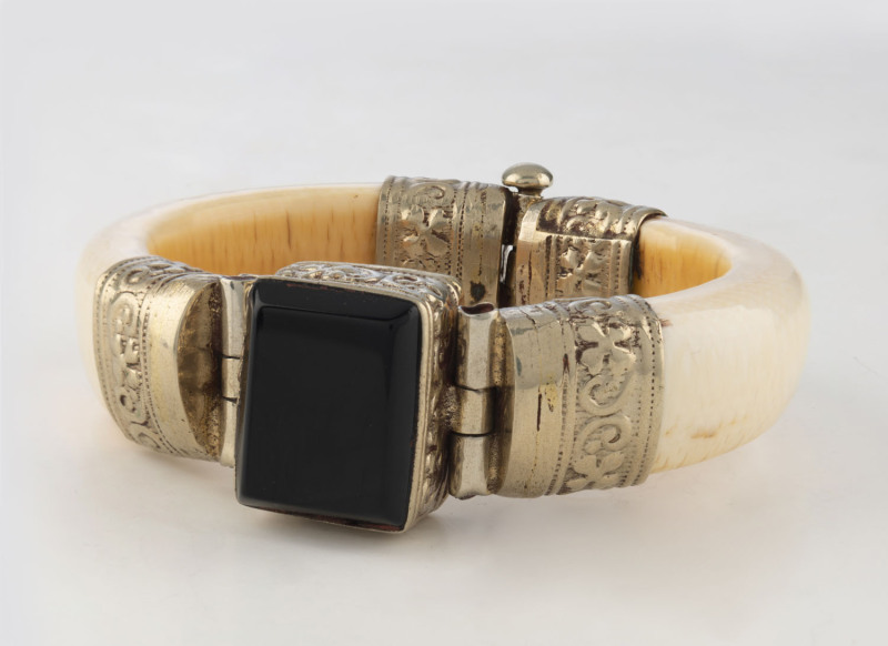 A Chinese ivory bangle set with onyx and silver, 20th century