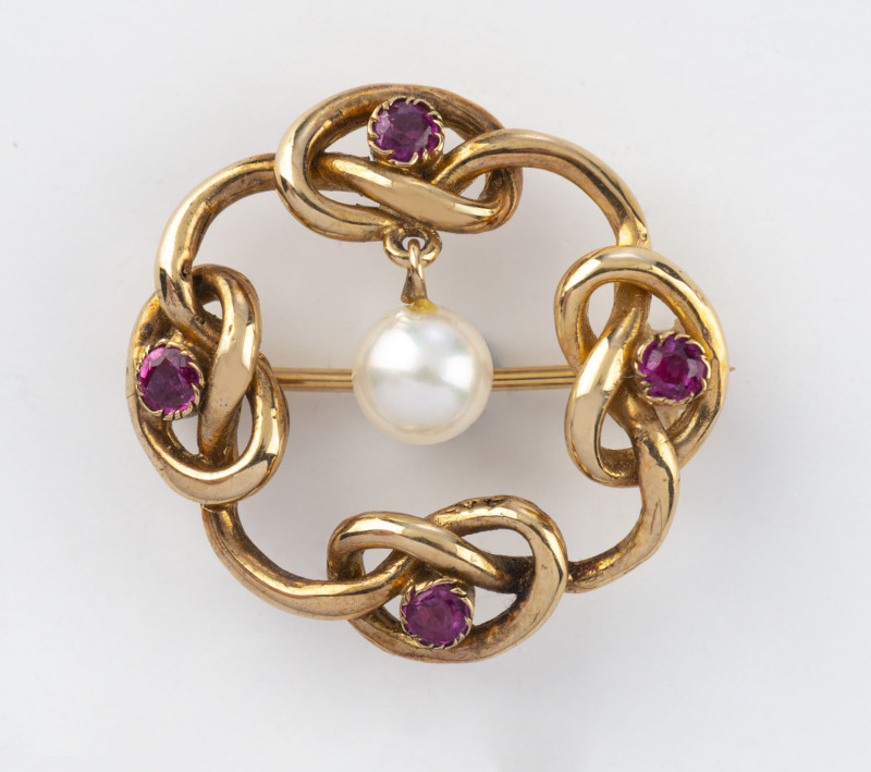 A 9ct gold brooch set with rubies and pearl, stamped 9ct, 2.5cm across, 4.5 grams