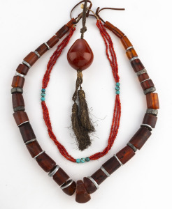 Three assorted tribal necklaces,coral, amber, turquoise and steel, early to mid 20th century.