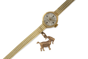 STOWA ladies wristwatch in 14ct yellow gold case and bracelet, with additional rose gold goat charm attached, gold weight approximately 14 grams