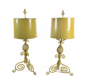 A pair of yellow painted wrought iron table lamps with shades, early 20th century, 125cm high