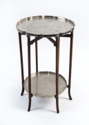 A Chinese two tier occasional table with silver plated tops and folding base, circa 1920, 54cm high, 38cm across