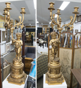 A pair of gilded three branch figural candelabra, 20th century, 130cm high