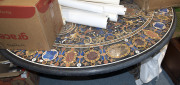 An Italian circular pietra dura stone top table on wrought iron base, 20th century