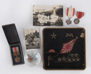 Japanese veteran of 2nd Sino-Japanese war mementos in a lacquered tray honouring his service in Korea; two original photos showing junior officers on medical leave, sake cup commemorating the 1935 China incident, China incident medal (cased); Order Rising