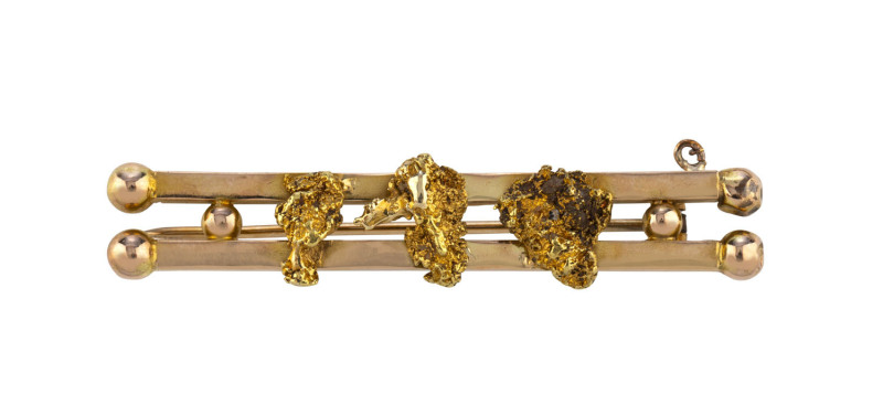 A South Australian goldfields double bar brooch set with three gold nuggets, late 19th century, stamped "18C" with crown, this mark was used by several Adelaide jewellers at the time. 5cm long, 9.2 grams