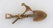 A gold miner's brooch, crossed pick and shovel with rope and nuggets 19th century. This brooch was found by metal detector in the Maryborough district. These brooches were often made in rose gold and then plated in yellow gold to hide the jewellers solder