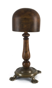 A shop display hat block, turned wood on brass base, late 19th century, 48cm high