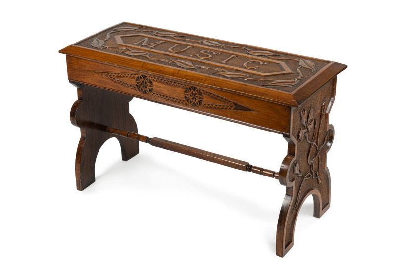 An Australian Arts and Crafts music seat, kauri pine carved with leaves and emblazoned "MUSIC" across the top, circa 1900, ​54cm high,86cm wide, 35cm deep