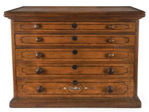 An unusual miniature chest of drawers, cedar and pine with inlaid escutcheons and monogram, lift top with tray compartments, 19th century, 55cm high, 73cm wide, 35cm deep