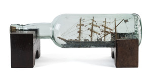 A ship in a bottle, late 19th century, 30cm long