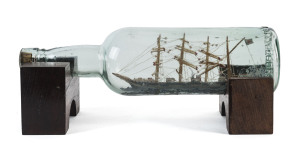 A ship in a bottle, late 19th century, ​30cm long