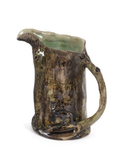WILLIAM RICKETTS early pottery tree stump jug with applied kangaroo and branch handle, the interior glazed in green, circa 1930s, inscription illegible, 13cm high