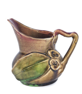 REMUED Pottery gumleaf and gumnut jug glazed in pink, green and brown, incised "Remued, Hand Made, 119M", 10.5cm high