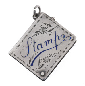 Stamp Boxes - Silver: 1909 Crisford & Norris single-size case in the form of a book with foliate engraved decoration and the word 'Stamps' highlighted in blue enamel, the silver gilt interior swivels open on a retaining pin, weight 11gr, hallmarked in Birmingham, minor scratching.