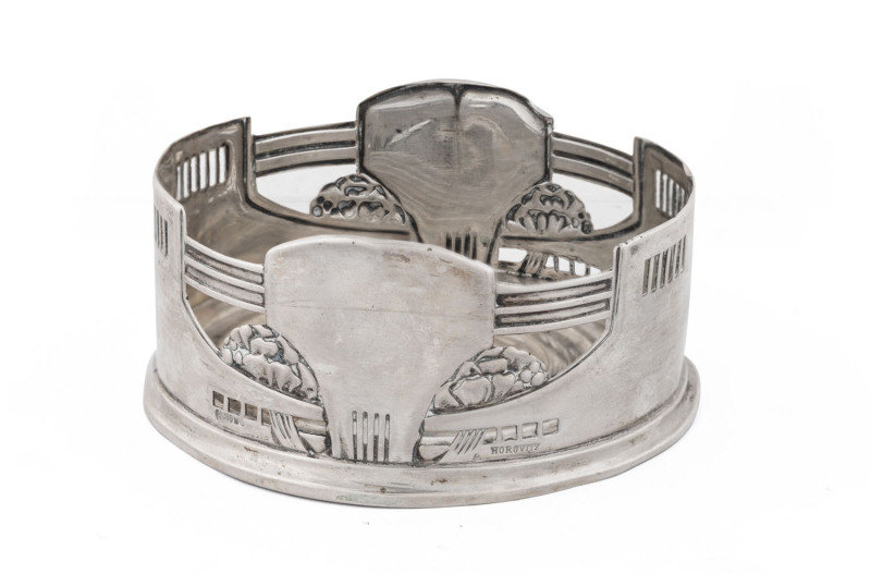 A German silver wine bottle coaster in the Arts and Crafts style, early 20th century, stamped 800 with crescent and crown mark, 9.5cm diameter, 72 grams