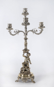 A silver plated four branch candelabra with cherub and dolphin base, 19th century, 48cm high