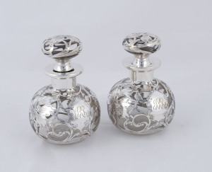 A pair of silver overlay bottles, 19th century, ​13cm high