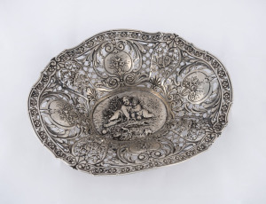An antique pierced silver bowl with cherub decoration, 19th century, marks illegible, 27.5cm across, 460 grams