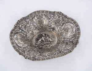 An antique pierced silver bowl with cherub decoration, 19th century, marks illegible, ​27.5cm across, 460 grams