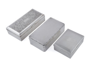 Three sterling silver cigarette boxes, early to mid 20th century, the largest 18cm across