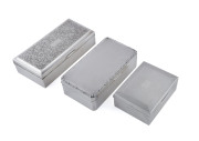 Three sterling silver cigarette boxes, early to mid 20th century, ​the largest 18cm across