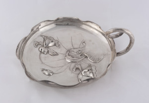 An Austro-Hungarian silver dish embossed with irises and with scrolled branch handle and three balled feet, circa 1900, 29cm diameter, 515 grams.