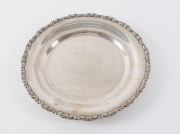 An Egyptian silver circular dish with scrolling rim, 20th century, 24cm diameter, 370 grams.