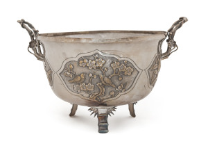 A Chinese silver plate two handled circular bowl with embossed panels of birds and lotus flowers, circa 1900, 28cm across, 17cm high.