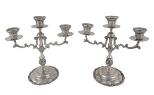 A pair of Mexican silver three branch candelabra with scrolling rims marked "Mexican Sterling, 925", 26cm high, 1745grams.