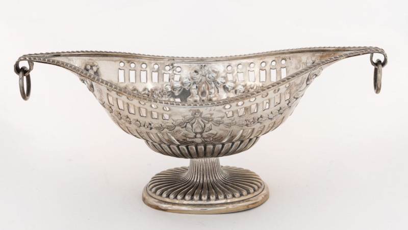 A George V sterling silver boat-shaped pierced bowl with two scrolling ring handles and embossed ribbon swags, by The Alexander Clark Manufacturing Co., London, circa 1927, 23.5cm across the handles, 225 grams.