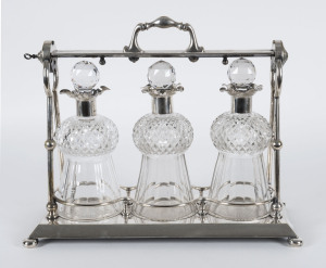 An antique three bottle silver plated tantalus set, circa 1870, 35cm high