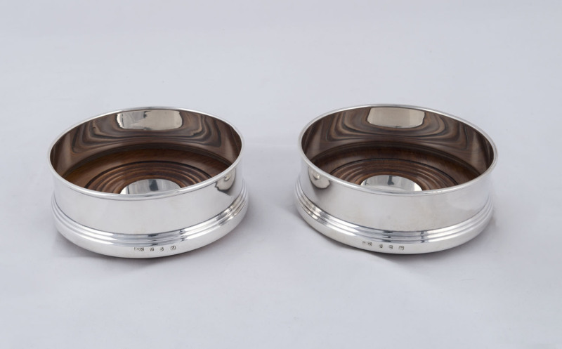 A pair of sterling silver wine coasters, mid 20th century, ​4.5cm high, 11cm diameter