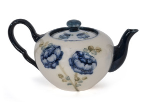 WILLIAM MOORCROFT (attributed) MACINTYRE blue floral teapot, circa 1905, stamped "Macintyre, Burslem, England", 11cm high, 20cm across