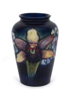 MOORCROFT "Orchid" pattern pottery vase on blue ground, circa 1930s, impressed signature mark "W. Moorcroft, Potters To H.M. The Queen, Made In England", 15.5cm high