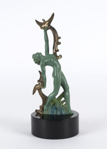 An Art Deco statue of a female nude with birds, patinated cast metal and slate, circa 1930, 23cm high