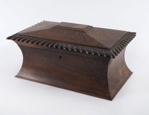 An English tea caddy of waisted form with dragooned edging, rosewood with original fitted interior and glass mixing bowl, early 19th century ​17cm high, 37cm wide, 23cm deep