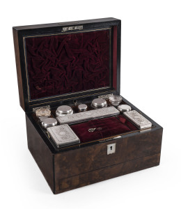 A ladies travelling dressing box, burr walnut sumptuously fitted with compartments and silver plated bottles, 19th century, with silver presentation plaque "Presented To Miss R. Grieve From The Friends Of The Gilmour Street Mission, Edin. 26th June, 1886", 18cm high, 30.5cm wide, 24cm deep