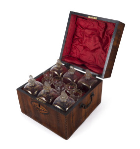 A Georgian six bottle decanter set in inlaid mahogany case, circa 1800, with original key and lock, the case 22cm high, 27cm wide, 27cm deep