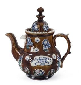 A Barge Ware pottery teapot with applied cartouche plaque "Mrs H. Bradley, Powick, Worcester, 1886", 28cm high