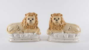 A pair of Staffordshire porcelain recumbent lions, mid 19th century, 20cm high