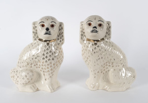 A pair of Staffordshire porcelain spaniel statues, mid 19th century, 36cm high