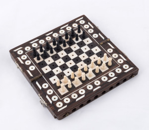 An Anglo-Indian traveling chess set, ebony and ivory, 19th century, ​15 x 15cm