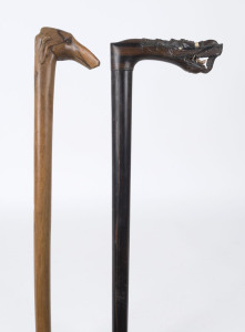 Two walking sticks with carved dragon and dogs head handles, Chinese and Continental, 19th century, ​91cm and 92cm high