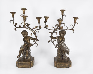 A pair of four branch putti figural candelabra, carved gilt wood and metal, 19th century, 75cm high