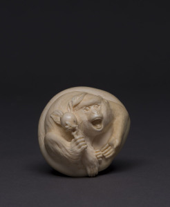 A Japanese netsuke carved ivory in the form of a monkey, signed "Himiko", 5.5cm across