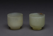 A pair of jade teacups, one with antique gold filled restoration, 18th/19th century, ​6cm high